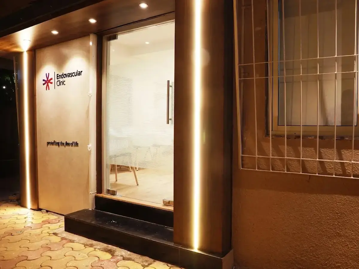 The Endovascular Clinic entrance in Mumbai at night, its lit signage reading “Endovascular Clinic — protecting the flow of life”.
