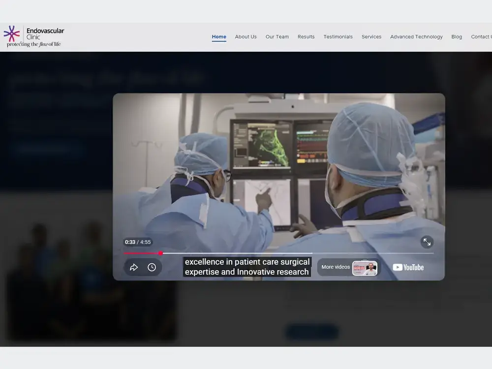The endovascularclinic.in homepage with its profile video playing — two doctors reading vascular imaging in the cath lab.